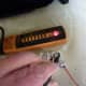 Testing the old tombstone. With a probe on each of the metal contacts where the lamp goes, the meter shows that they are connected together internally. This tombstone is not appropriate for a single ended LED lamp.