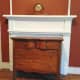 Dresser in front of closed off fireplace