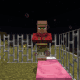 A cured villager waits out the night in the iron bar prison.