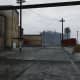 The yard with the last truck, guarded by armed gunmen.