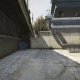 Climb over this wall, past the gate, at the East end of the police station (the second vehicle B).