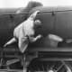 One of the cleaning staff at a Midland Region shed 'rejuvenates' a locomotive nameplate with a lick of paint