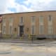 Strangely the post office near the Henry Holmes Murder Castle looks more like the school in-game.