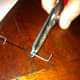 Step Two:  Slip the pushrod tip over the pushrod and crimp it tightly with a crimper (pliers work well too).
