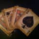 A decoration showing four playing cards. Decorations like this can be used in playing card collections.
