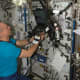 Expedition 15 Flight Engineer Clay Anderson works with a Continuous Blood Pressure Device (CBPD) and computer.