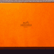Real Hermès tie boxes are a distinctive bright orange. Fakes will be off-color and may not have the same font on the printing. This one is legit!