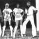 The well-known band, ABBA, wearing white disco clothing.