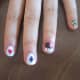 To make your heart into a clover like in this Harley Quinn inspired nail art design, make your two dots, then a third dot on top, and draw the triangle stem with a toothpick.