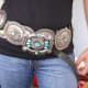 #3 large concho belt with turquoise over a black shirt and blue jeans