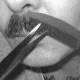 Tidying a mustache: Run the comb lightly over one half of the mustache. Hairs that don't lie flat will poke through its teeth.