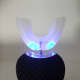 V-White 360° Electric Toothbrush. Blue light indicates unit is in whitening mode