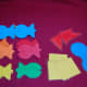 Sorting fish and laminated shapes by color.