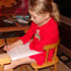 Grace is an eager writer and continues to seek out opportunities to write in her new notebook.