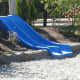 Some natural playgrounds contain slides, but the slides are built into a slope to make them safer.