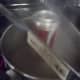 Place the can, open end into the bubbling water supported by tongs.