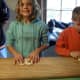 Kids learn what it was like to fold pretzels by hand.