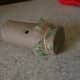 A toy kazoo, made from a toilet paper roll.