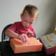 Use stickers, foam letters, and other embellishments to decorate your cardboard city.
