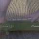 Slide the Velcro tabs through the slots in the two corners and then stick them to the underside of the Pack 'n Play.