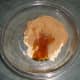 Adding honey to ground seeds.