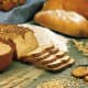 Barley (lower left), and oats (upper right), and bread and cookies made from the grains.