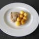 Plate the pork and the roast potatoes.