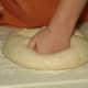 Punch down the risen dough.