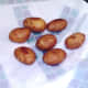 Deep fried potatoes are drained on kitchen paper