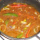 Vegetables and black bean sauce are brought to a simmer