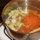 Prepared vegetables are added to chicken stock