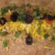Next, add some cheese, cilantro, tomatoes and olives.