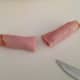 5. Roll one piece of deli meat up and slice in half.