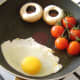 Egg is fried with the tomatoes and mushrooms.