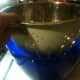 Placement of the colander and bowl. You'll ladle the stock into the colander to catch all of the vegetable pieces and chicken pieces that you haven't removed yet.