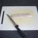 Fillet is laid on a chopping board, skin side down
