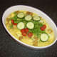 Cucumber, tomatoes and coriander/cilantro are added to the casserole