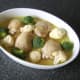 Broccoli and cauliflower florets are interspersed between the chicken thighs