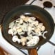 Frying the onion and mushrooms in the chicken juices