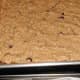 Cookie dough spread into a half size sheet pan. Line the bottom with parchment paper for easy removal.