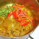 Chopped vegetables are added to sauteed spices