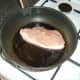 Pan frying a leg of pork steak