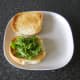 Rocket/arugula is added to bottom of roll