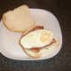 Fried egg is laid on top of bacon