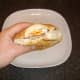 Tucking in to a steak, bacon and fried egg sandwich