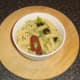 Fusilli pasta is spooned in to a small serving bowl