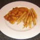 Chips are plated with the breaded sea bream fillets