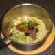 Sun dried tomatoes, olives and parsley are added to fusilli pasta