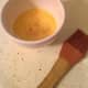 Crack an egg into a cup or bowl and whisk the egg until the white and yolk are nicely combined.