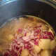 Add the onion and potato and allow the filling to cook until the potatoes and carrots are almost fully cooked.